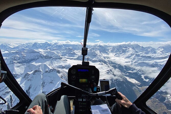 Private Swiss Alps helicopter tour over snow covered mountain peaks and glaciers - The Eiger north face above Grindelwald